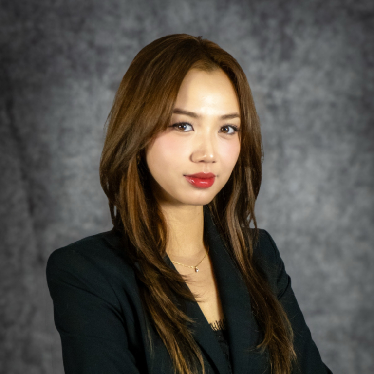 Professional woman in black blazer, studio portrait