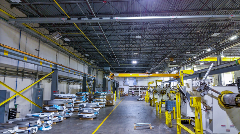 Industrial warehouse aisle with stacked metal coils