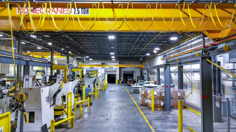 Yellow overhead crane and hanging cables