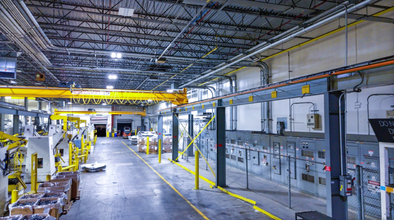 Manufacturing floor with conveyor and control panels