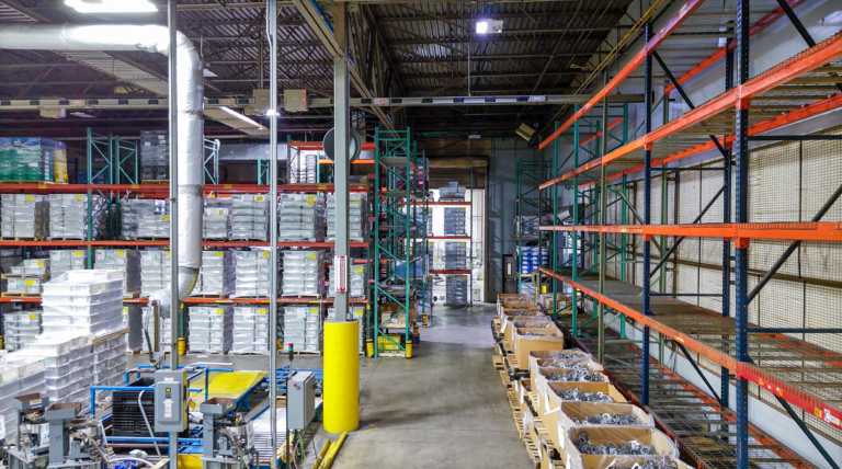 Warehouse racks and pallets beside yellow pillar