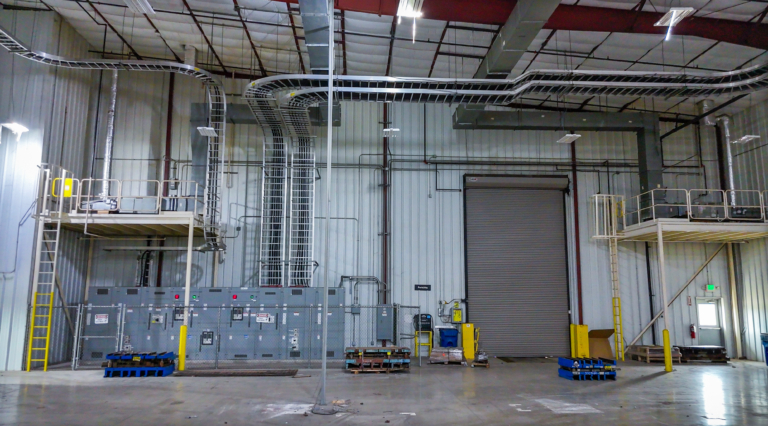 Industrial cable trays above electrical panels