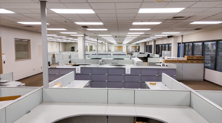 Empty open office with cubicles and cabinets