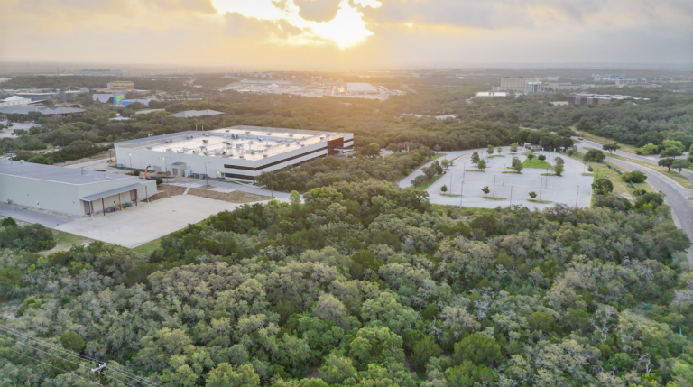 Aerial sunset view over warehouse and parking